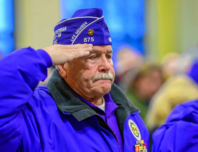 Vietnam War veteran and Purple Heart recipient, Lenny Desrochers, a resident of Granby, salutes during South Hadley’s National Vietnam War Veterans Day Commemoration at the South Hadley Public Library on Thursday.