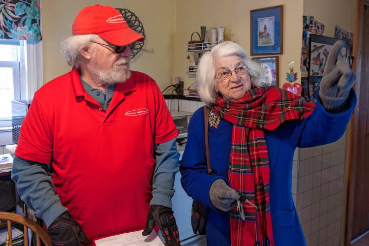 Rick Dunderdale, who delivers meals on wheels for WestMass ElderCare, drops off Therese Purcell’s meal at her home in Holyoke. She waits for his delivery in the morning before going out to meet friends for coffee.