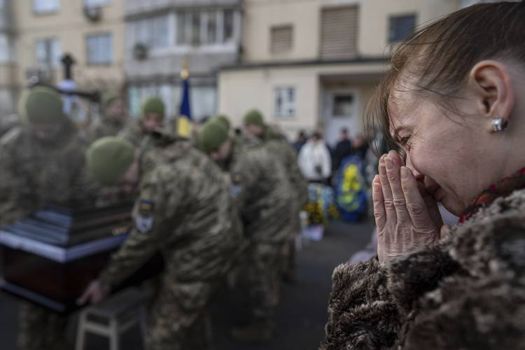 A woman cries during a funeral ceremony of Volodymyr Golubnychyi, Ukrainian senior lieutenant of 72nd Mechanized Brigade, in Kyiv, Ukraine, on Wednesday, Feb. 28, 2024. Golubnychyi was killed during the fighting with Russian forces in Vodyane village, Avdiivka direction, on Feb. 19.