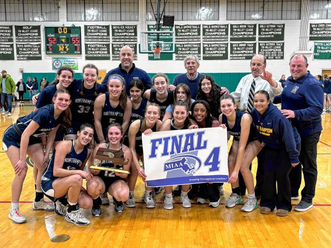 The No. 7 Northampton girls basketball team poses with the Final Four trophy and banner following its 55-52 victory over No. 2 Walpole in the MIAA Division 2 quarterfinal round on Friday night at Westwood High School.