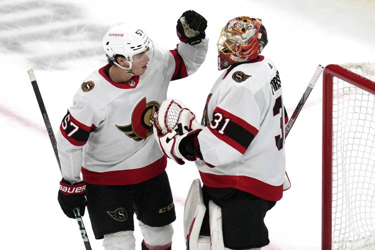 Ottawa Senators goaltender Anton Forsberg (31) is congratulated by center Shane Pinto after the team's win over the Boston Bruins in an NHL hockey game Tuesday, April 16, 2024, in Boston. (AP Photo/Charles Krupa)
