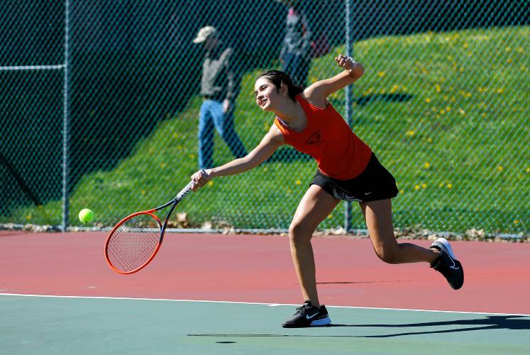 South Hadley’s Estella Estrada lunges to returns a shot from Belchertown’s Ava Shea during their No. 1 singles match Thursday at Mount Holyoke College.