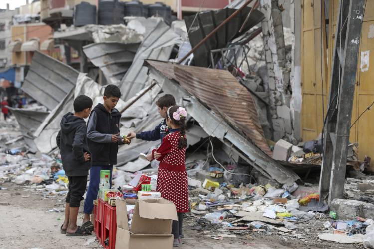 Palestinian children sell sweets in front of the rubble of a destroyed building in Jebaliya refugee camp in the Gaza Strip on Nov. 28.