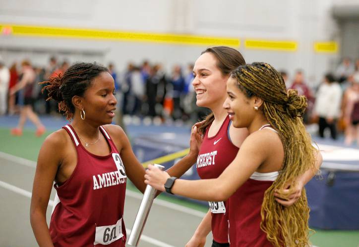 Amherst’s Kora Brissett, from left, Ruby Austin and Ololara Baptiste react after a first place finish in the girls 4x200 meter relay, along with Ella Austin, during the PVIAC indoor track meet Wednesday at Smith College in Northampton.
