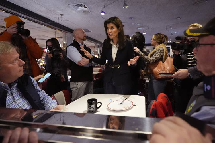 Republican presidential candidate  Nikki Haley, center, chats with guests during a campaign stop at Mary Ann’s Diner, Friday, in Amherst, New Hampshire.   