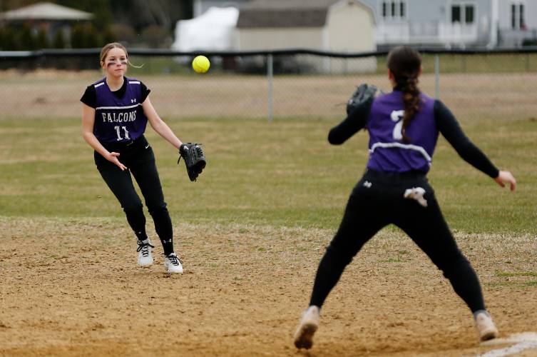 Smith Academy second baseman Anna Scagel (11) tosses to Emilia Neves (7) for an out at first against Granby in the bottom of the first inning Wednesday in Granby.