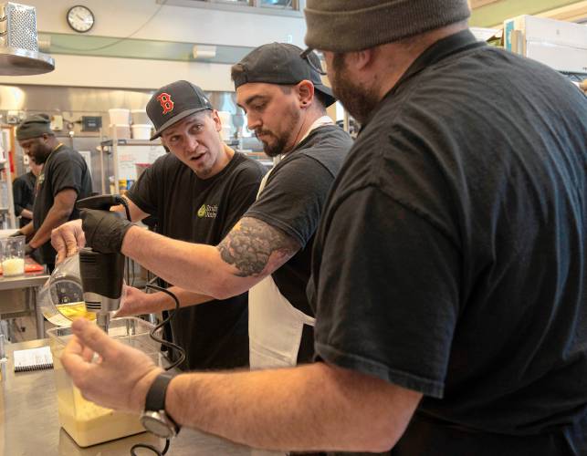 Julian Martin, Dave Dejordy and Moises Torres, chefs with residential dining at Smith College, discuss aquafaba mayo during a training session led by the National Humane Society and focused on plant-based foods for breakfast and brunch. The college has pledged to ensure that more than 50% of its entree items are plant-based. 