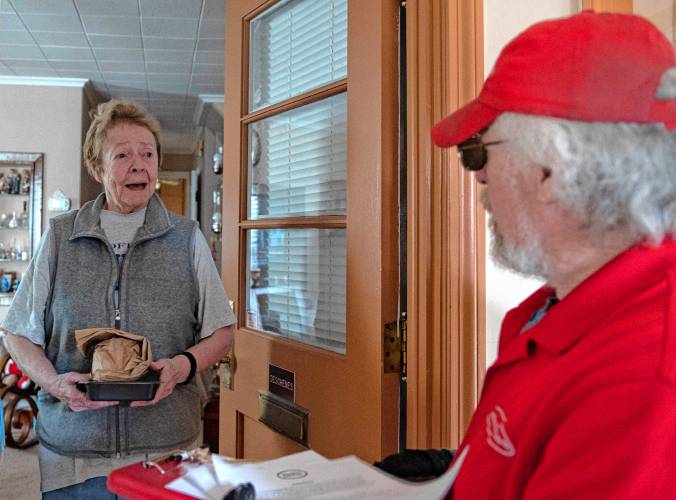 Rick Dunderdale, who delivers meals on wheels for WestMass ElderCare, drops a meal off to  Mary Deschenes at her home in Holyoke on Monday. The two talk about her latest eye surgery and Deschenes explains what a comfort it is to have Dunderdale check on her in the mornings. “It’s nice to see a friendly face,” says Deschenes.