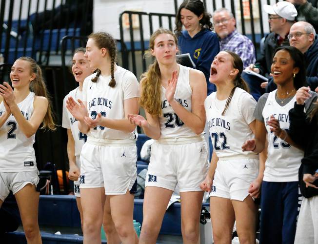 Northampton players cheer on the sideline in the last seconds against Mansfield in the fourth quarter of the MIAA Division 2 girls basketball round of 16 game Tuesday night in Northampton.