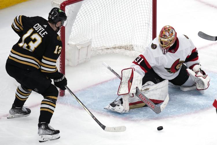 Ottawa Senators goaltender Anton Forsberg (31) makes a save on a shot by Boston Bruins center Charlie Coyle (13) during the second period of an NHL hockey game Tuesday, April 16, 2024, in Boston. (AP Photo/Charles Krupa)