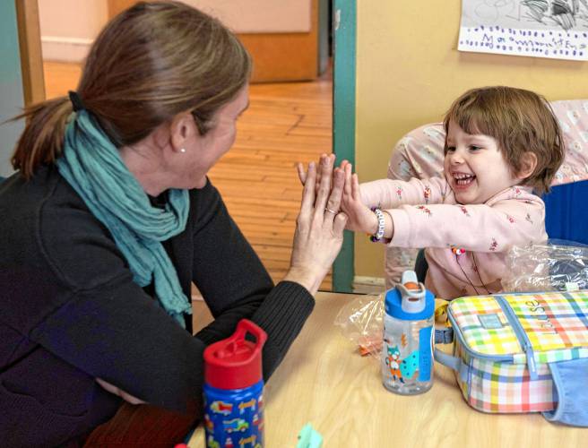 At left and above: Sara Allium, a special education teacher works with Louise Tobey,4, at Nonotuck Community Child Care, as part of the Northampton Public School itinerant program which works with preschool students with special needs in Community programs.