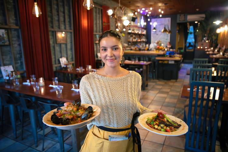Nyah Forth holds the seafood jambalaya and blackened catfish dishes at Gombo Nola Kitchen & Oyster Bar on Main Street in Northampton.