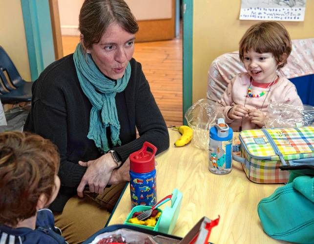 Sara Allium, a special education teacher works with Louise Tobey,4, at Nonotuck Community Child Care, as part of the Northampton Public School itinerant program which works with preschool students with special needs in Community programs. Allium helps the preschoolers navigate social skills, transitions, and self help skills so that the child can participate in all aspects of their class room setting. Allium helps Tobey think through how much more time she has for snack before music starts.