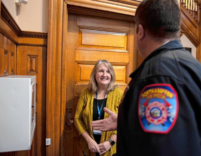Forbes Library Director Lisa Downing talks with Matt Lemberg, assistant fire chief for the Northampton Fire Department, about the new automated external defibrillator machine the library received as a donation form the Northampton Lions Club on Wednesday morning.