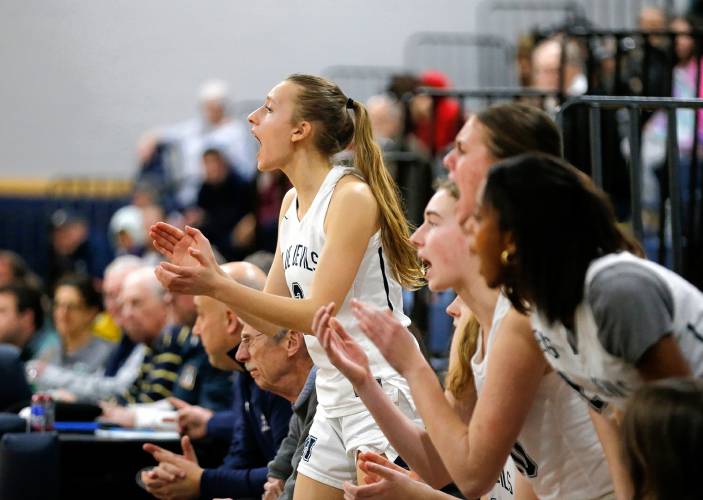 Northampton’s Sarah Molnar cheers with the sideline players in the fourth quarter against Mansfield during the MIAA Division 2 girls basketball round of 16 game Tuesday night in Northampton.