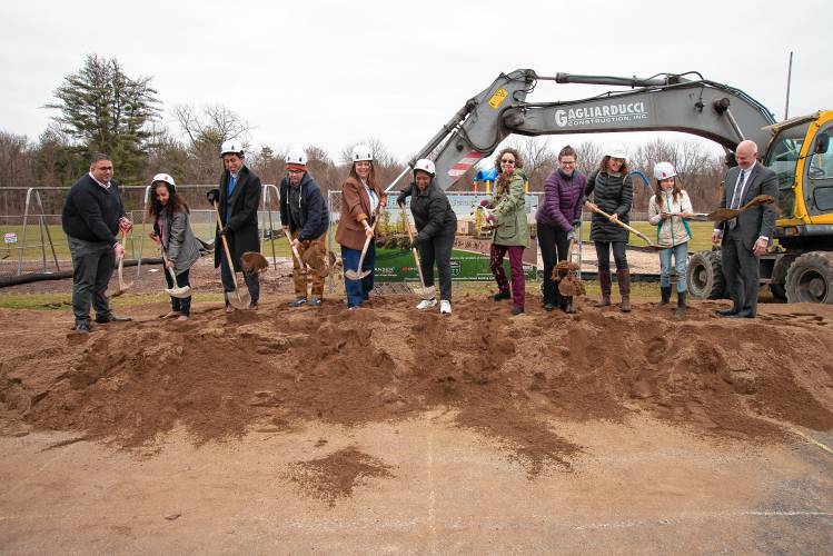 Past and present school administrators, family members and students at groundbreaking at a Tuesday groundbreaking for construction of a new elementary school in Amherst.