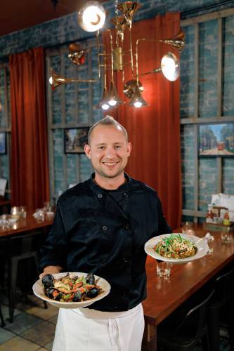 Owner and chef John Piskor with his seafood jambalaya and Cajun Boom Boom dishes at Gombo Nola Kitchen & Oyster Bar on Main Street in Northampton.