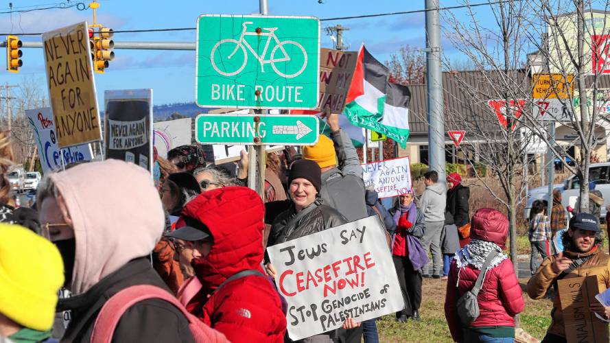 Batya Sobel, a member of the western Massachusetts chapter of Jewish Voice for Peace, holds up a sign reading “Jews say ceasefire now! Stop genocide of Palestinians,” during a protest held along Route 9 in Hadley on Friday. 
