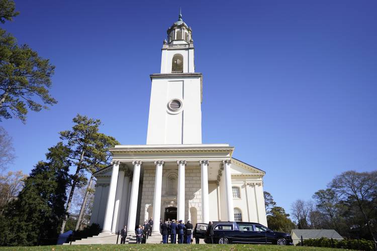 An Armed Force body bearer team moves the casket of former first lady Rosalynn Carter upon arrival at Glenn Memorial Church at Emory University for a tribute service on Tuesday, Nov. 28, 2023, in Atlanta. (AP Photo/Mike Stewart)