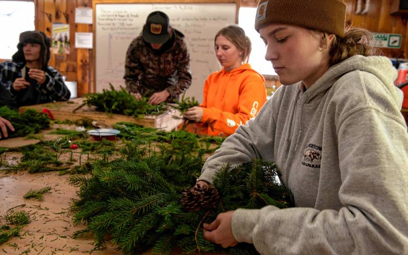 Smith Vocational and Agricultural High School student Violet Geoffrion makes wreaths with other students in the  half of the horticultural building not lost to fire last year. The school is looking to raise the remaining $750,000 of a $6.7 million project to construct a new building. Back left is Trent Bush, Sam Jenkins and Shelby Frey.