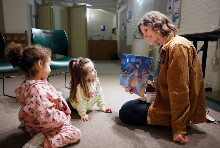 Sarah Johnson, head of children’s and young adult services, reads “Snowmen at Night” by Caralyn Buehner to Riley Desjardins, 3, and Ceara Martin Rodriguez, 3, during preschool storytime at Forbes Library in Northampton in March 2023.