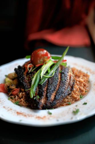 The blacked catfish dish with jambalaya rice and seasonal vegetables at Gombo Nola Kitchen & Oyster Bar on Main Street in Northampton.