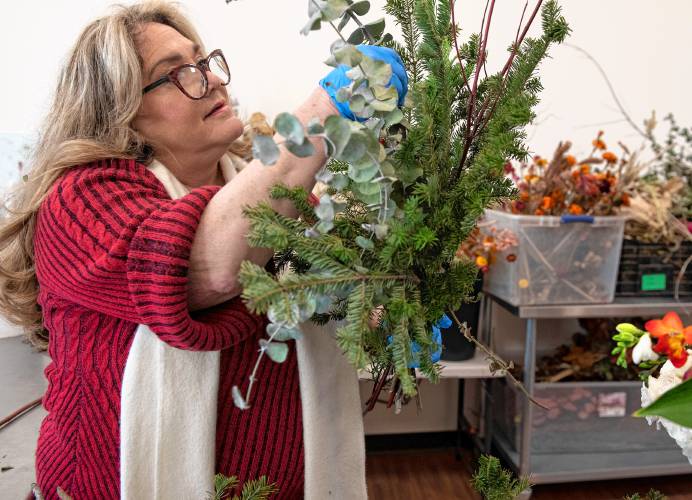 Deborah Maillet works on an arrangement at Many Graces Farm and Design in the new storefront in Northampton. Her daughter, Rebecca Maillet co-owns the business with Kel Komenda. 