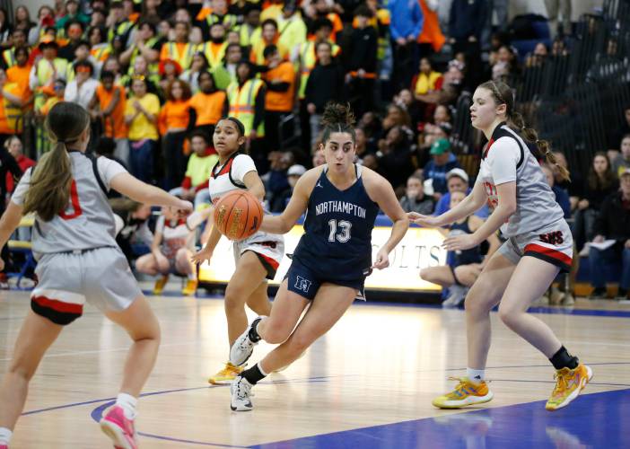 Northampton’s Ava Azzaro (13), middle, drives the ball between Worcester South defenders Lydia Charlonne (0) and Madi Leighton (13) in the third quarter of the MIAA Div. 2 girls basketball state semifinals Tuesday night at Chicopee Comp High School.