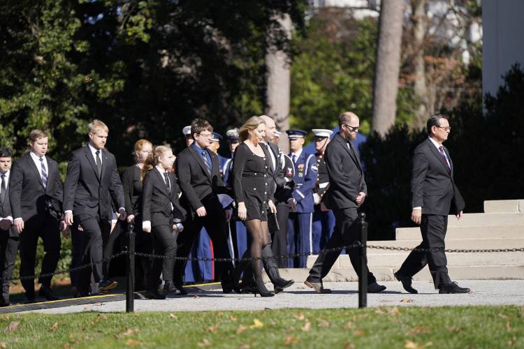 Carter family members walk as the casket of former first lady Rosalynn Carter arrives at Glenn Memorial Church at Emory University for a tribute service on Tuesday, Nov. 28, 2023, in Atlanta. (AP Photo/Mike Stewart)