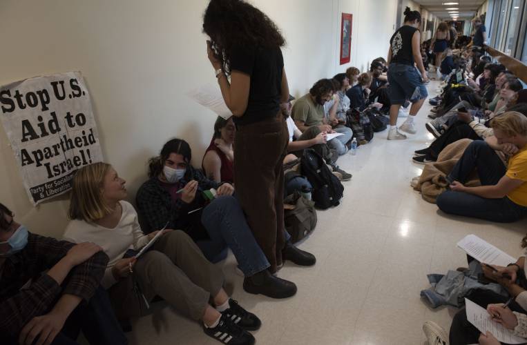 UMass students gather outside the chancellor's office in Whitmore during  a walkout and sit-in event on Wednesday to demand that the university cut ties with weapons manufacturers and condemn Israeli actions in Gaza. 