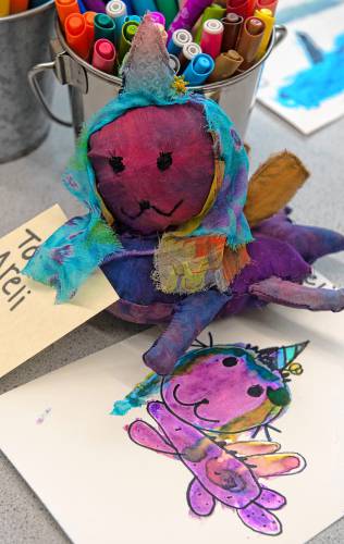 A drawing made by Areli Bereolos, a kindergartener at Crocker Farm and a fiber sewn stuffed animal inspired by Bereolos' drawing made by Ivorie Arguin, an Amherst High School student in a fiber arts class.