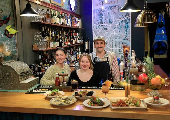 The staff at Gombo Nola Kitchen & Oyster Bar, from right, Sam Baluzy, Kyah Woofenden and Nyah Forth on Friday evening in Northampton.