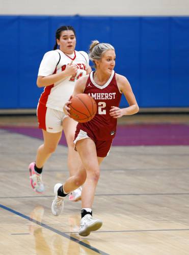 Amherst’s Francesca Sloan (2) drives up the court against Hampshire in the second quarter Friday night in Westhampton.