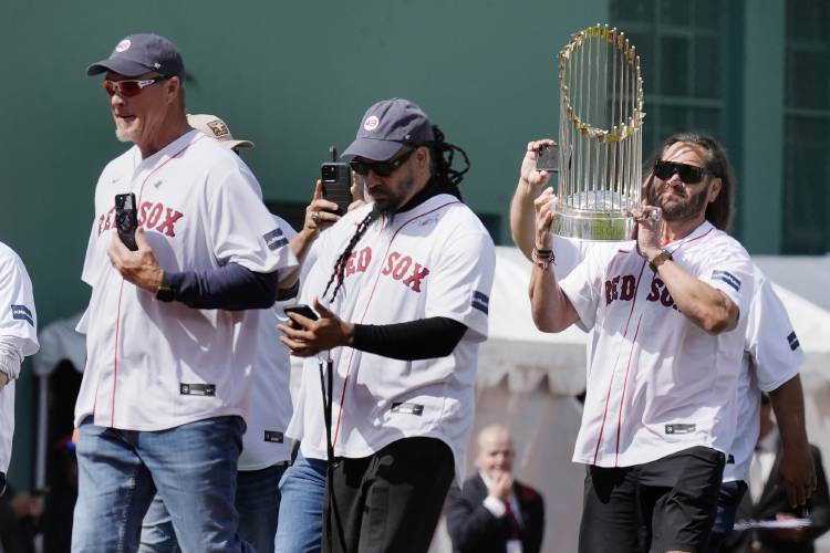 Members of the 2004 Boston Red Sox World Series championship team, Johnny Damon, right, Manny Ramirez, center, and Mike Timlin take the field during ceremonies before an opening day baseball game at Fenway Park against the Baltimore Orioles, Tuesday, April 9, 2024, in Boston. (AP Photo/Michael Dwyer)