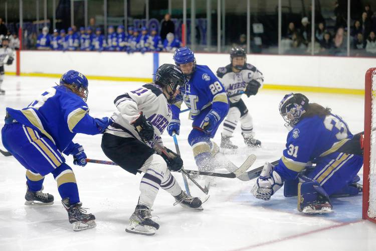 Amherst College’s Mary Thompson (11) fires a shot saved by Hamilton goalie Mac Donovan (31) in the third period of the NESCAC women's hockey semifinals Friday night at Orr Rink in Amherst.