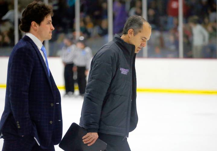 Amherst College head coach Jeff Matthews and assistant coach Zac Steigmeyer walk off the ice at half time of the NESCAC women's hockey semifinals against Hamilton on Friday night at Orr Rink in Amherst.