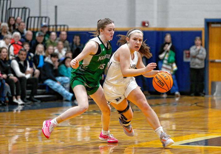 Northampton’s Bri Heafey (5) drives down the court defended by Mansfield’s Sophia Foley (25) in the fourth quarter of the MIAA Division 2 girls basketball round of 16 game Tuesday night in Northampton.