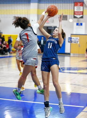 Northampton’s Anna Oravec (11) puts up a shot contested by Worcester South defender Jaiyla Colon (1) in the fourth quarter of the MIAA Div. 2 girls basketball state semifinals Tuesday night at Chicopee Comp High School.