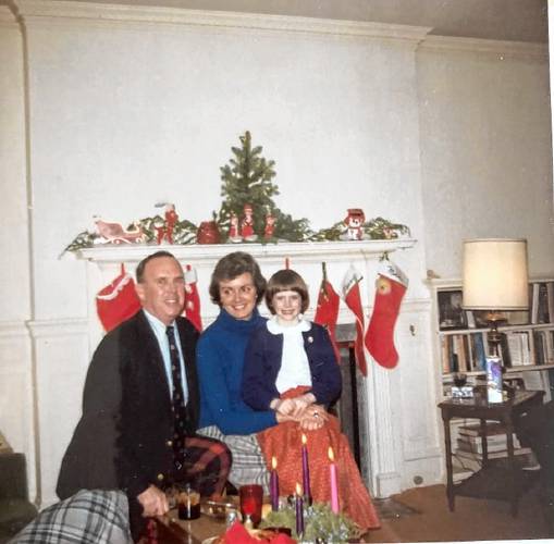 Kara McMahon with her mother, Mary McMahon, and father, Ed McMahon, by the fireplace during Christmastime in an undated photograph. 