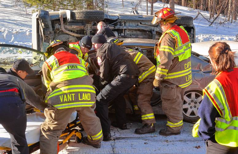 Northampton emergency personnel remove the driver of a car involved in a three-car crash.