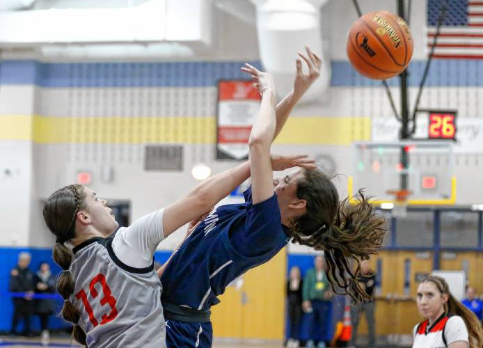 Northampton’s Emme Calkins (4) gets contested on her way to the hoop by Worcester South defender Madi Leighton (13) in the third quarter of the MIAA Div. 2 girls basketball state semifinals Tuesday night at Chicopee Comp High School.