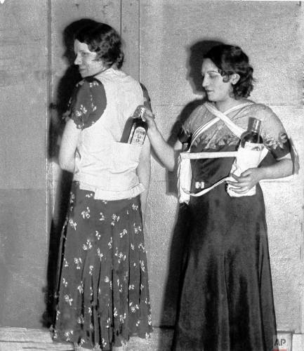 Estelle Zemon, left, and an unidentified woman model ways to conceal bottles of rum to get past customs officials during the U.S. alcohol prohibition in 1931.