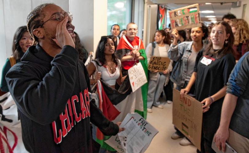 UMass students gather outside the chancellor's office in Whitmore during  a walkout and sit-in event on Wednesday to demand that the university cut ties with weapons manufacturers and condemn Israeli actions in Gaza. 