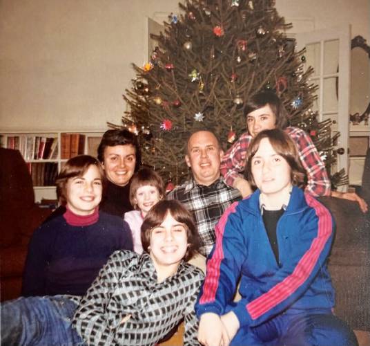 The McMahon family poses in front of the Christmas tree, with Ed McMahon at the center.