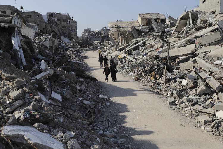 Palestinians walk through the destruction from the Israeli offensive in Jabaliya refugee camp in the Gaza Strip on  Feb. 29.