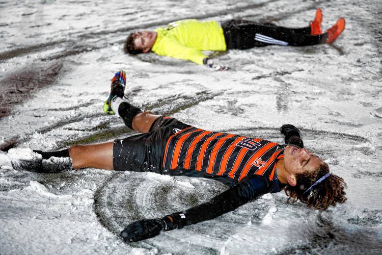 South Hadley’s Carlos David, front, and Eddie Wykowski celebrate by making snow angels after defeating Frontier in overtime to win the Division 4 boys soccer state semifinal in West Springfield in November 2022.