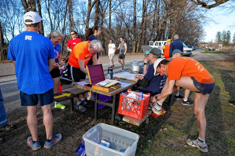 Runners check in and prepare for the Northampton Cross-Country 5K Race Series on Tuesday evening in Northampton.