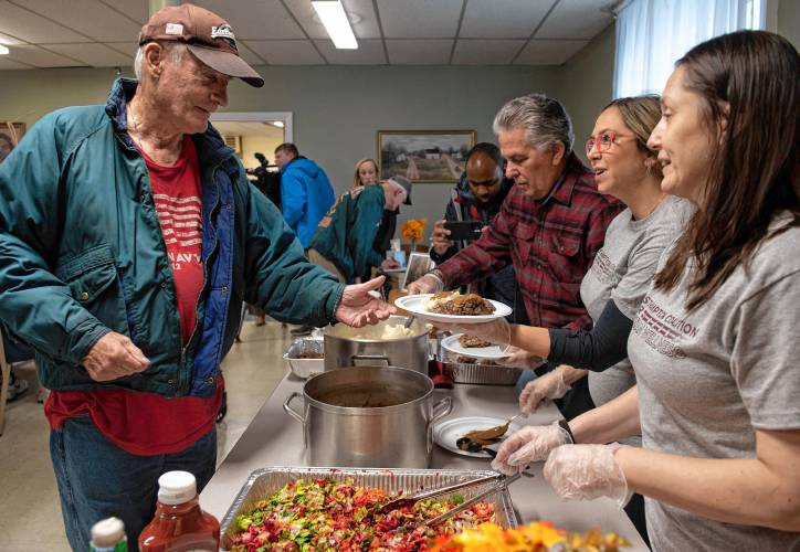 Veteran Jim Boyle grabs some lunch at the inaugural monthly luncheon sponsored by the Easthampton Coalition for Veterans Wellness in partnership with   Building Bridges.  Serving food is left, Bruce Sylvia, Jillian Hynek, and Angelique Baker.