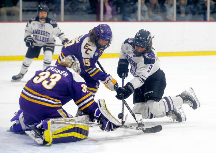 Amherst College’s Gretchen Dann (3) fights for the puck against Elmira College goalie Chloe Beaubien (33) and defender Lexi Hoffmann (15) in the third period of the NCAA quarterfinals Saturday afternoon at Orr Rink.