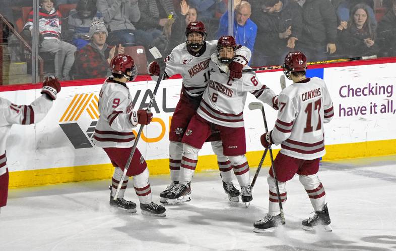 UMass players celebrate Ryan Ufko’s (6) goal during the Minutemen’s 4-3 overtime win against UMass Lowell on Saturday night at the Mullins Center in Amherst.